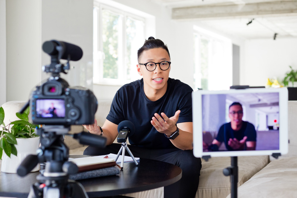 A presenter recording a video in front of a camera